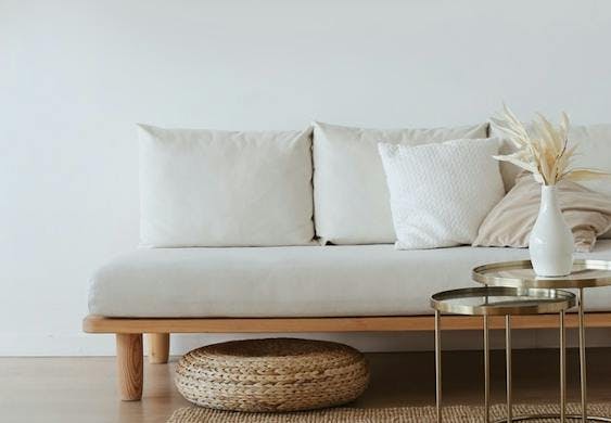 White couch with wooden base